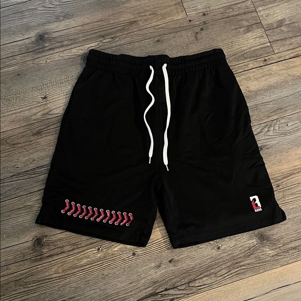Stylish Black Athletic Shorts with Red Accent
